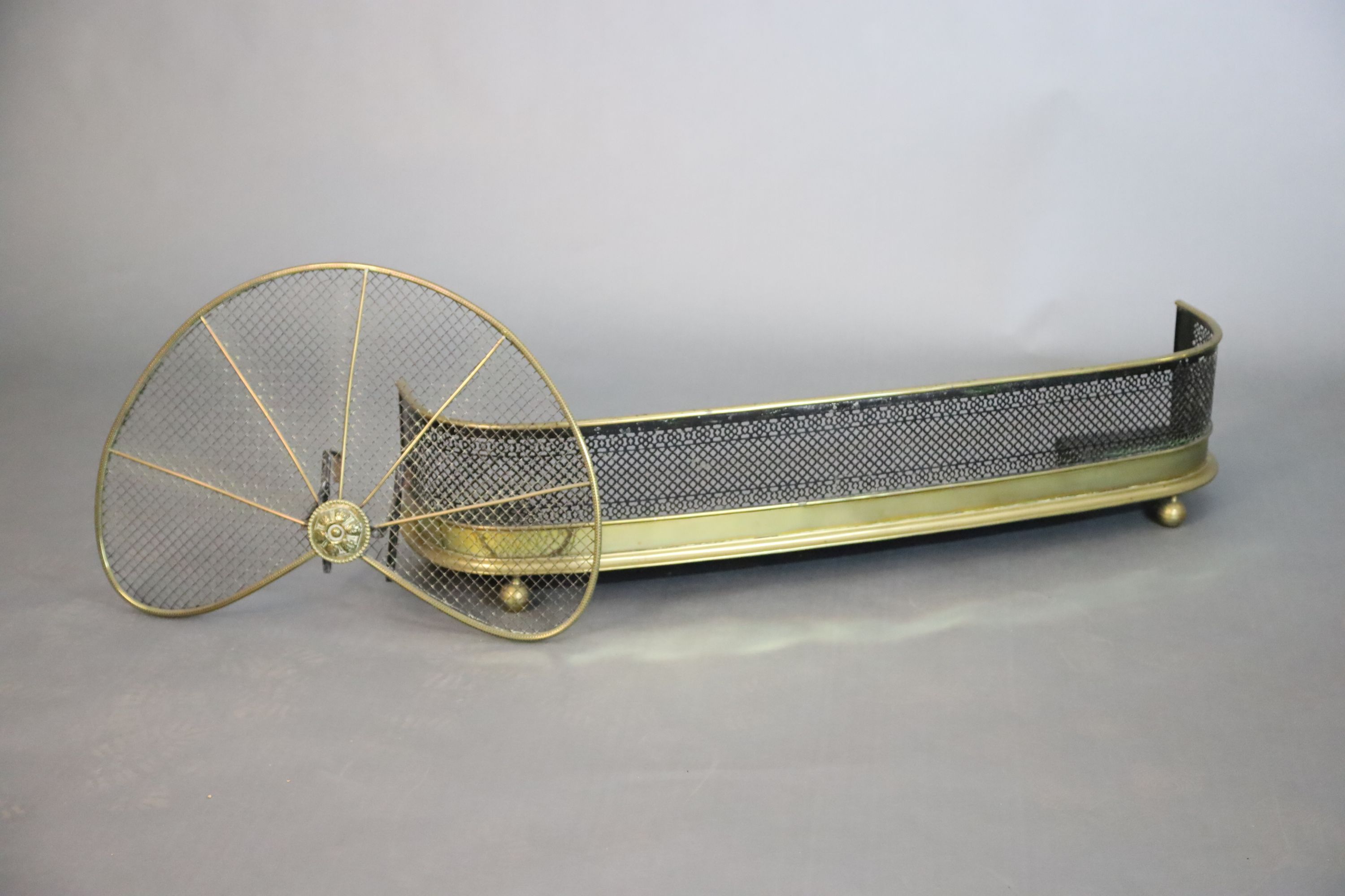 A Regency brass and wire mesh bow fronted kerb and a brass fan shaped spark guard, kerb W.119.5cm D.25.5cm H.27cm guard W.71cm H.46cm